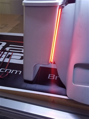 red and amber LED bagger strips mounted between motorcycle fender and saddlebags
